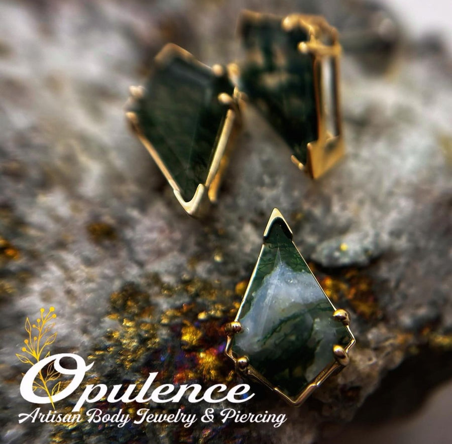 Gold body jewelry with dark geometric gemstone settings