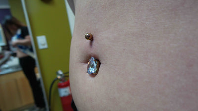 Blue gemstone jewelry worn in a navel piercing