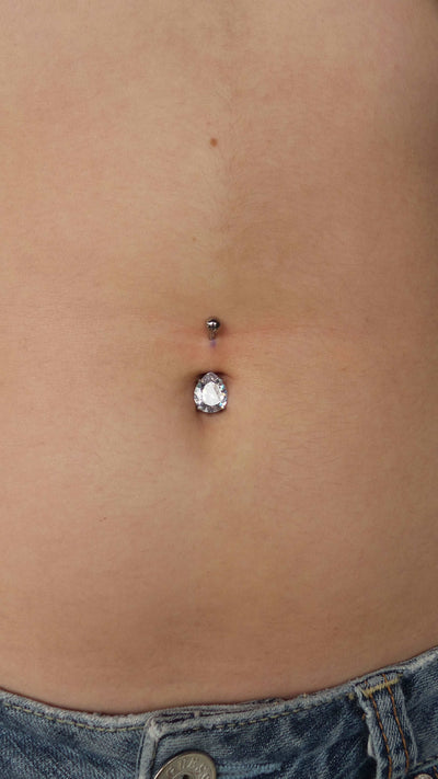 Clear gemstone jewelry worn in a navel piercing