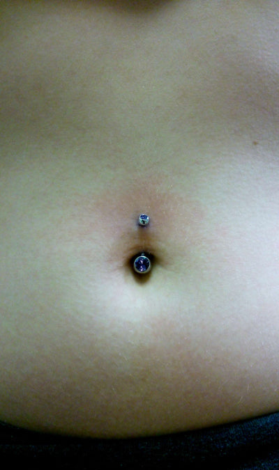 Blue gemstone jewelry worn in a navel piercing