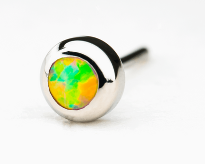 Green and yellow synthetic opal in a polished titanium threadless setting