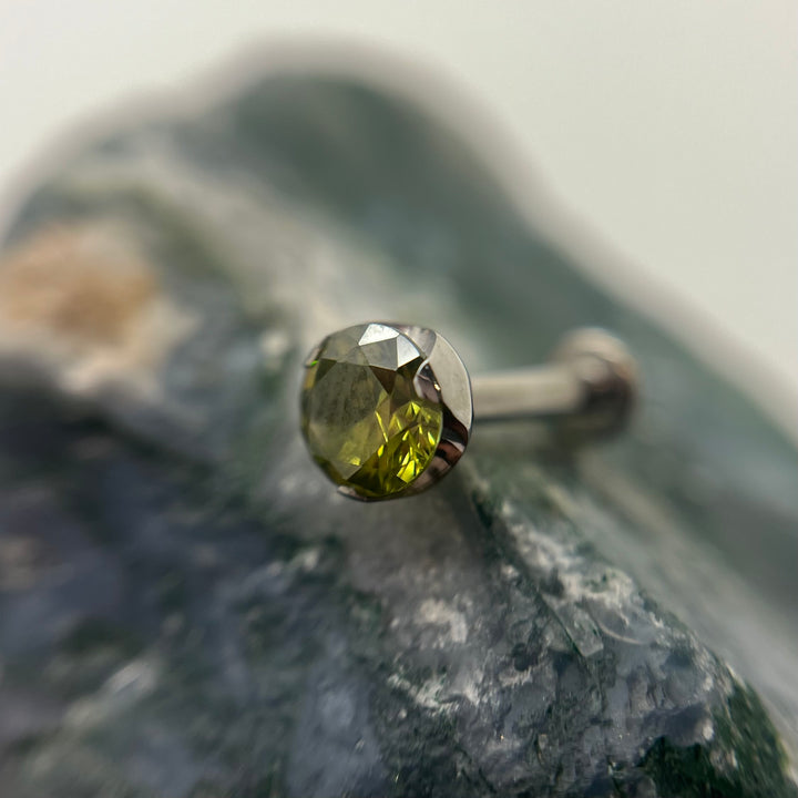 Olive-coloured 3 mm prong-set titanium bead with backing, made in Calgary