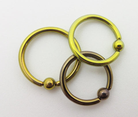 Anodized implant grade titanium captive bead rings