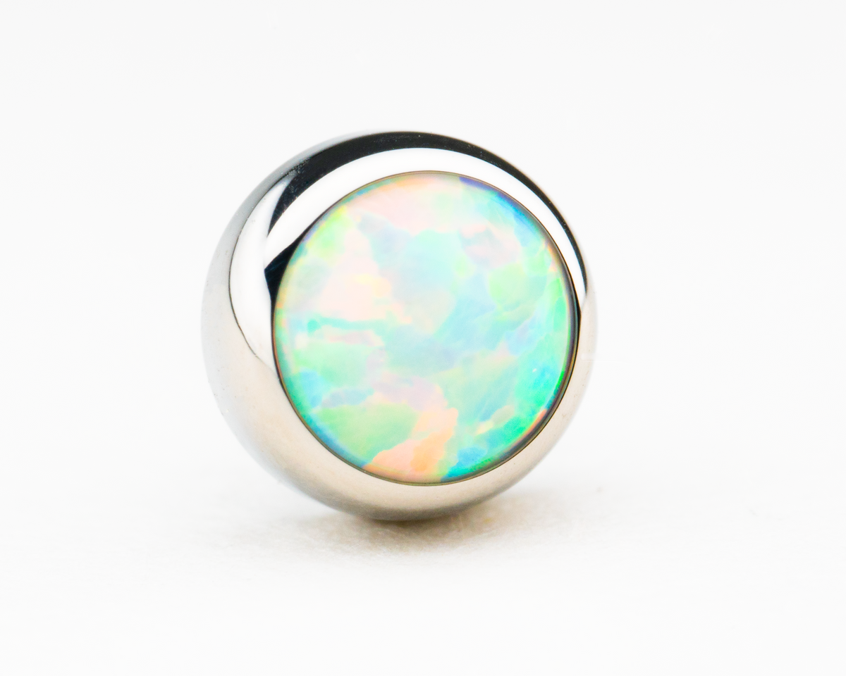 Pale blue-white synthetic opal in a polished titanium threadless setting